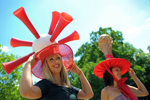 Racegoers pose for photographers with their World Cup themed hats.jpeg