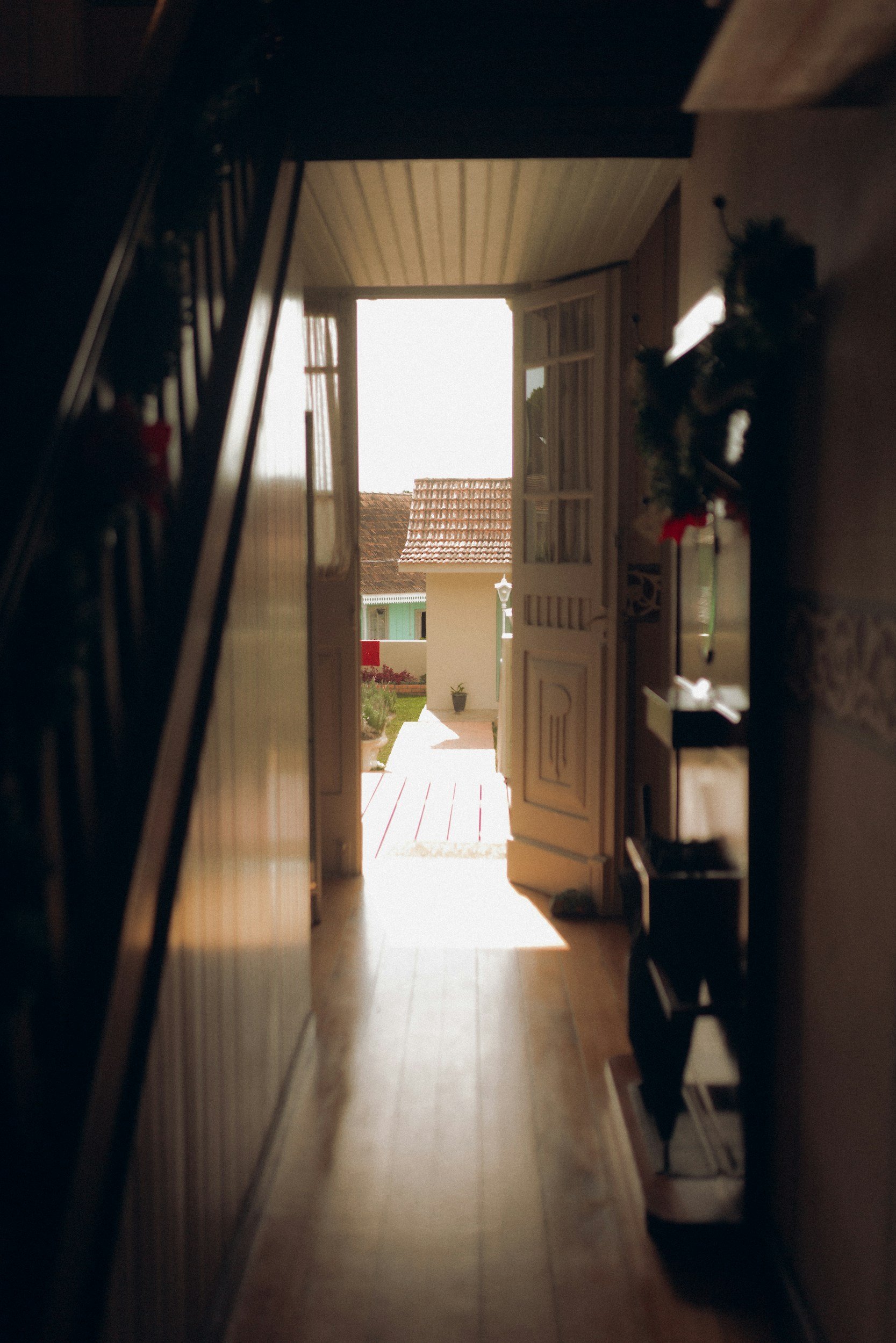 An open door leading out to a back garden.