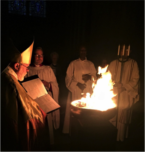 Bishop Andrew Dietsche lights the new fire of Easter.