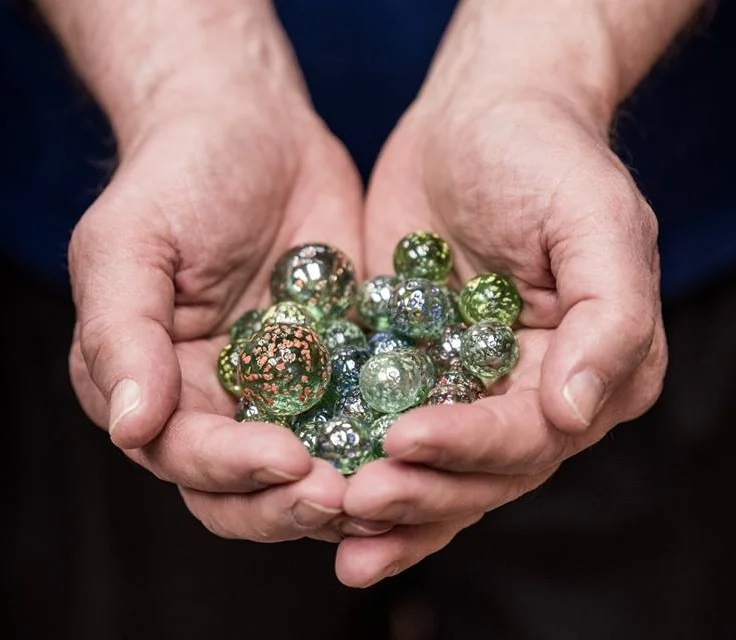 A handful of the unique blue marbles we were offering to audiences during the 2018 Water Docs Film Festival.
