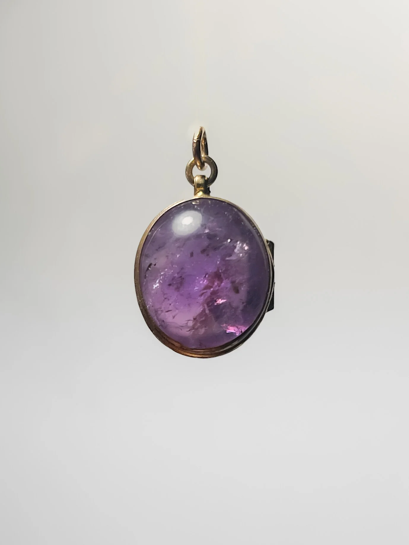 an oval shaped amethyst cabochon pendant