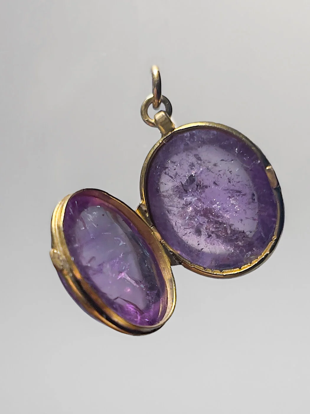 an amethyst gemstone locket open