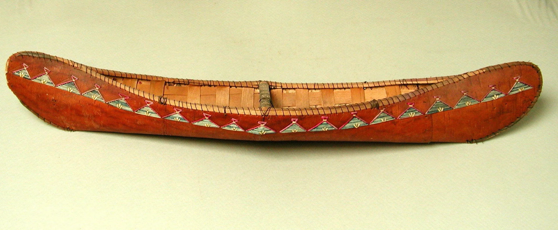 A scale model of a Mi’kmaw birchbark canoe made using the same materials. From the collection of the Metropolitan Museum of Art, New York.