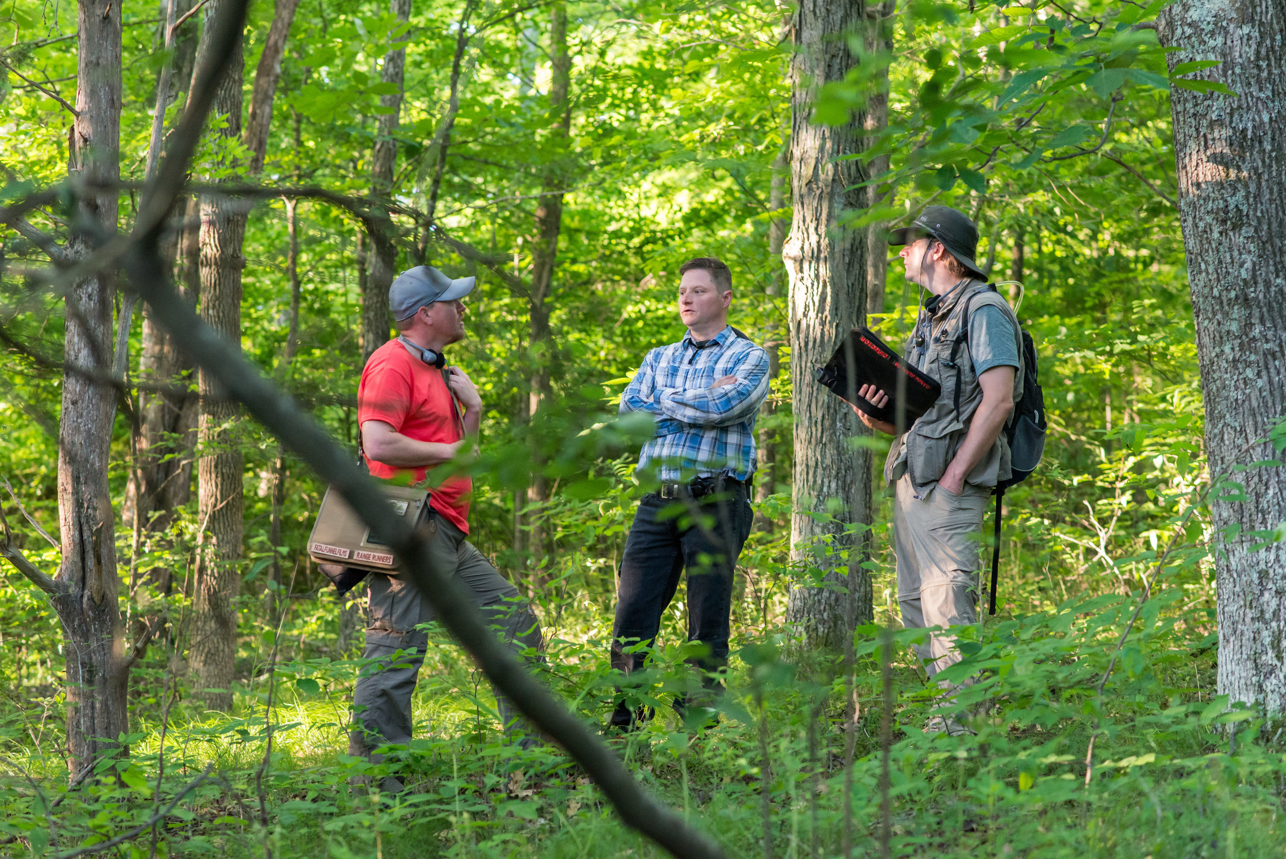  Devon Colwell, Darryl Miller, and Philip S. Plowden discuss a shot in the woods.   Photo credit,  Nathan Fortmeyer  