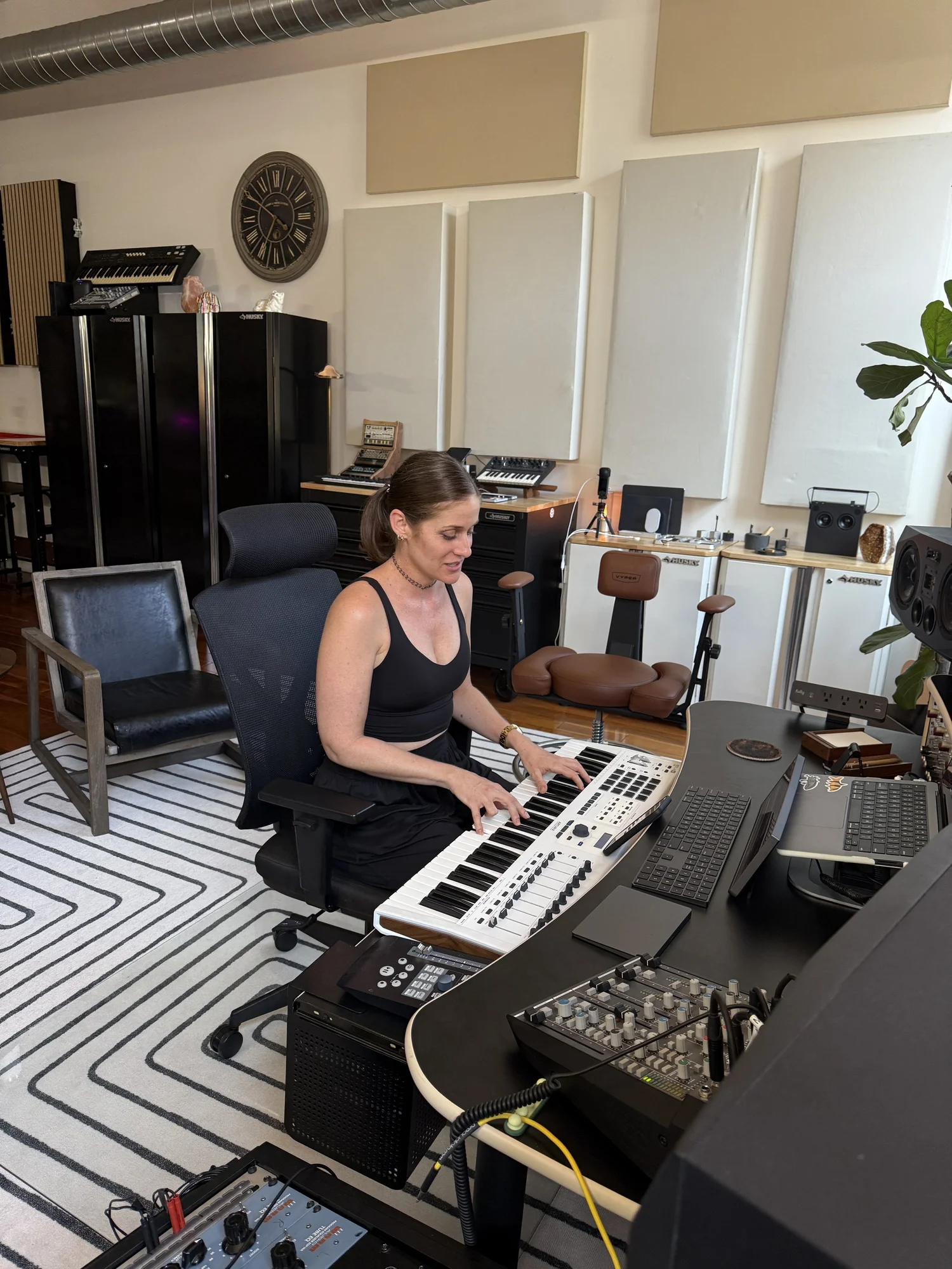 A musician seated at a keyboard in the Silver Gun Records studio
