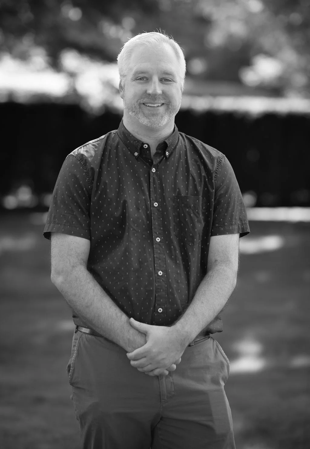 Mike smiling. Hands crossed. BW.jpg