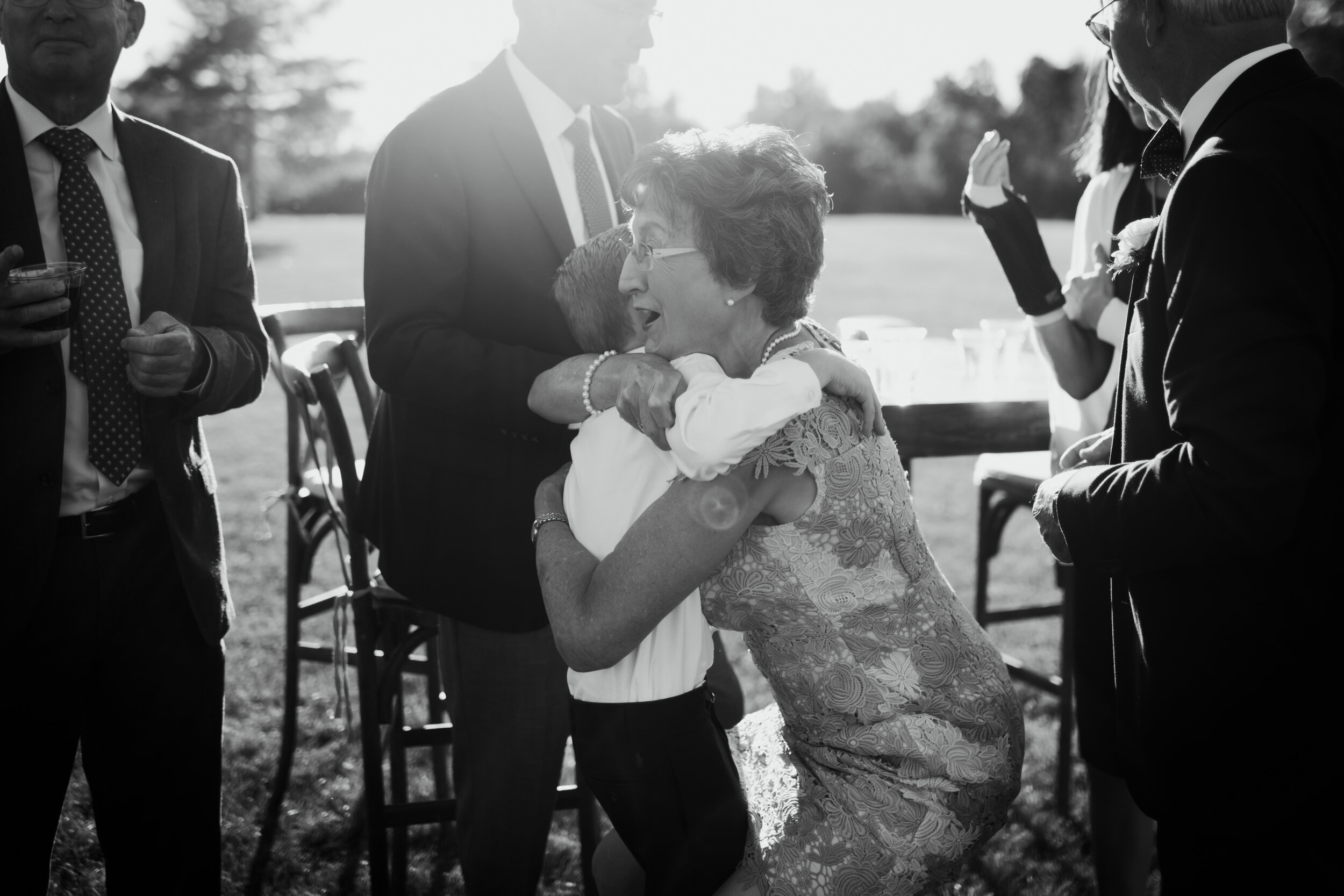 Grandma hugs grandson at wedding at Epiphany Farms