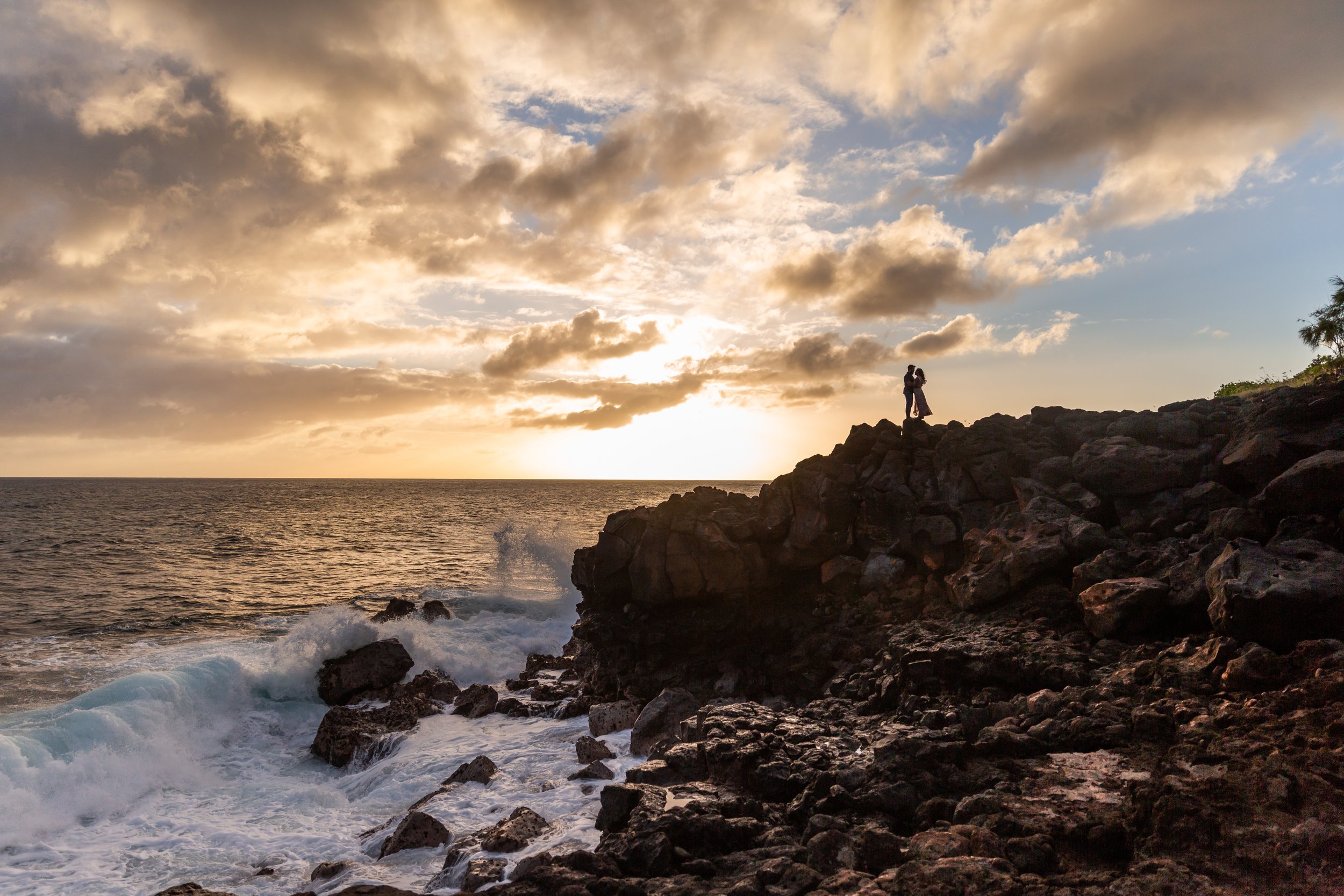 Couple on a cliff in Kaui Hawaii