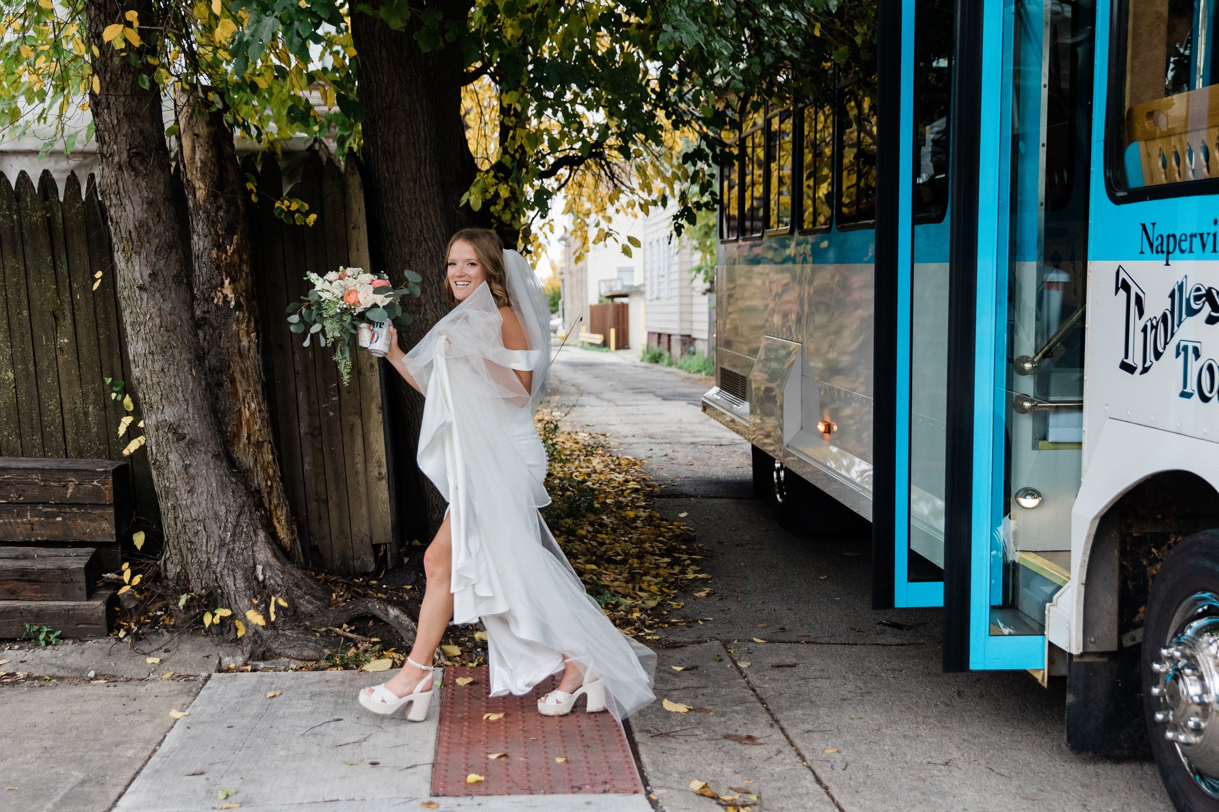 Candid photo of bride stepping off of trolly at Fitzgeralds in Berwyn.