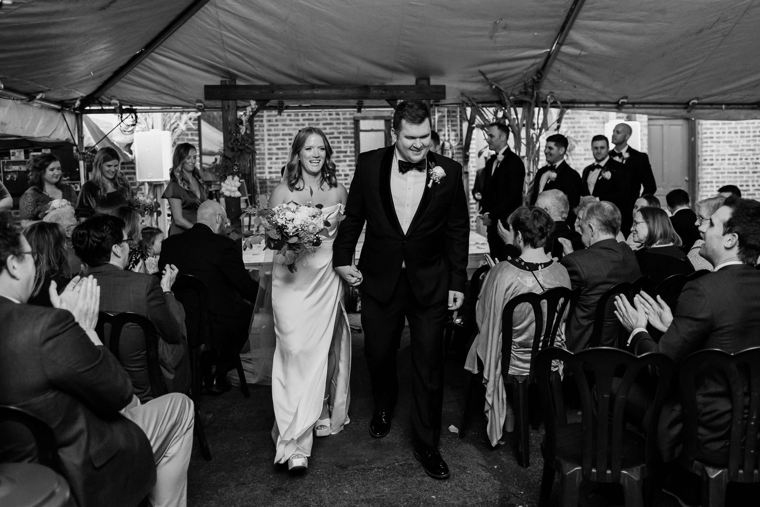 Bride and groom walk back down the isle after their vows at Fitzgeralds in Berwyn.