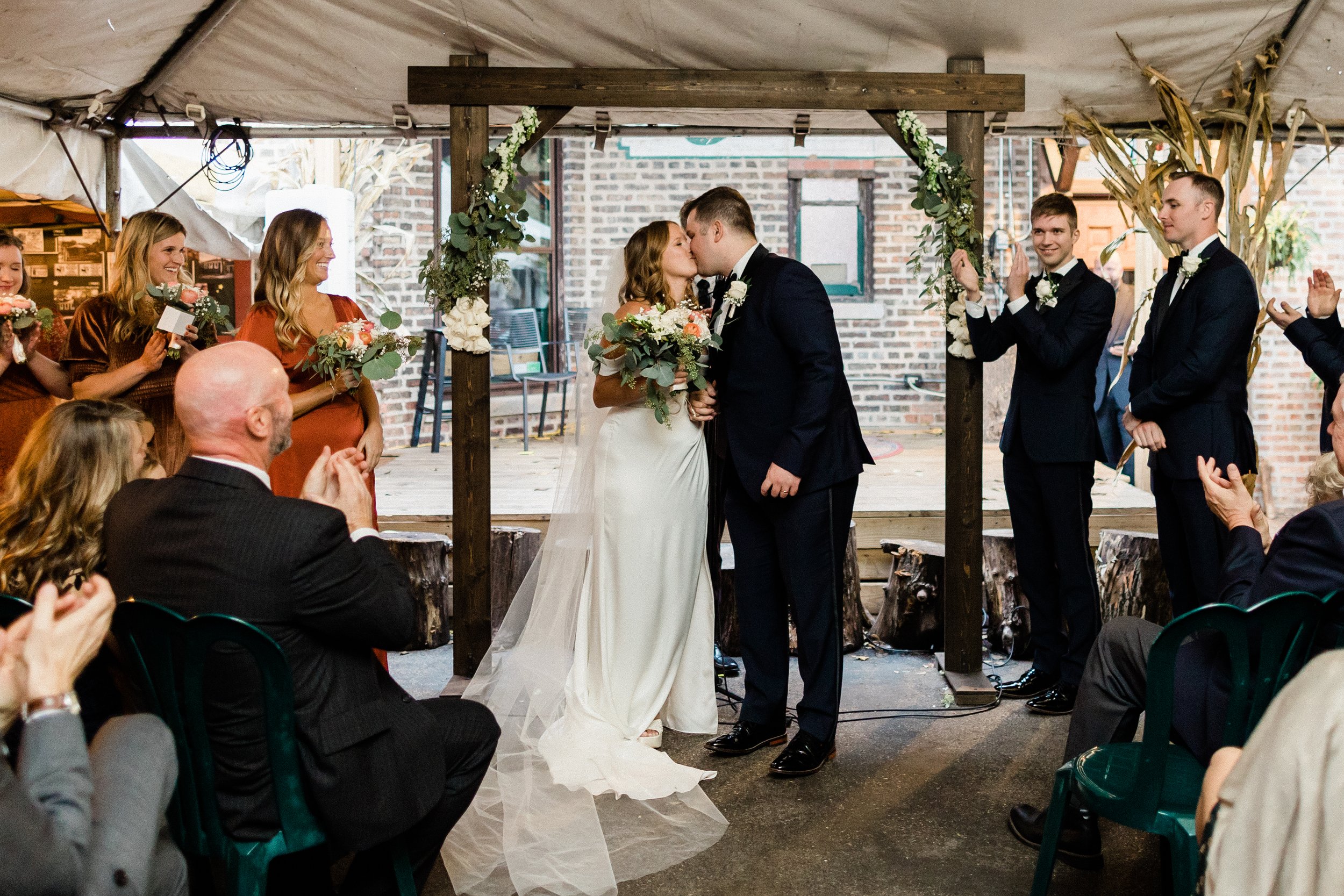 Bride and groom share their first kiss at Fitzgeralds in Berwyn.