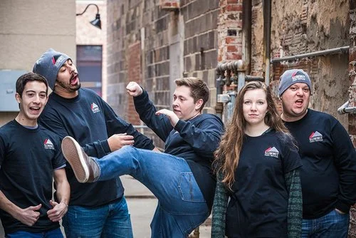 the summit video services team posing on a staircase