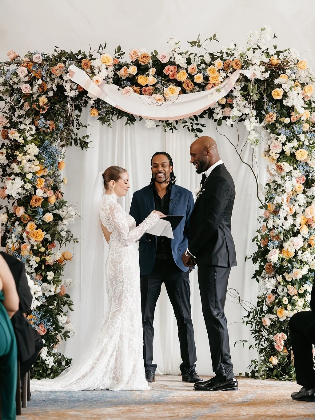 Designing this floral arch was all about creating a backdrop that felt as joyful and abundant as the love being celebrated. Layers of garden roses, delicate branches, and soft draping framed the &ldquo;I do&rsquo;s&rdquo; with a touch of romance and 