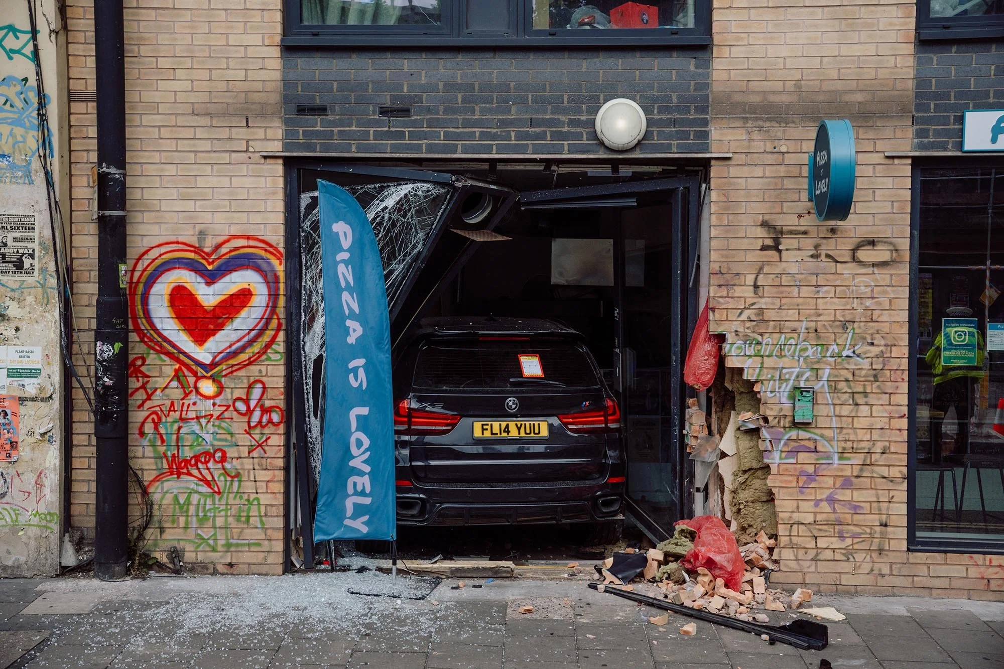 Pizza is Love Drive Through. Stokes Croft, Bristol. 2025.