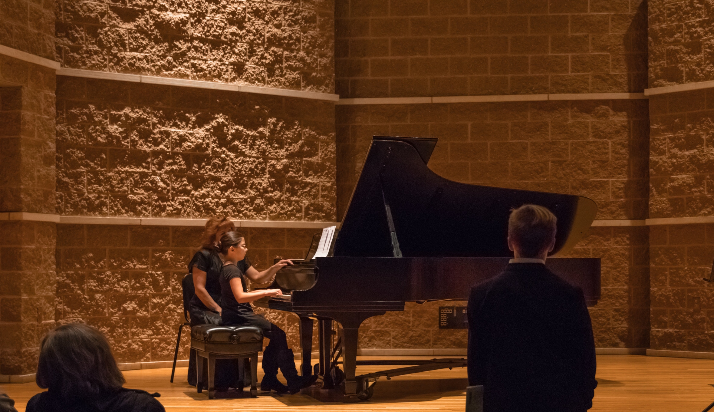 kid playing piano with janice with kid in foreground-1.jpg