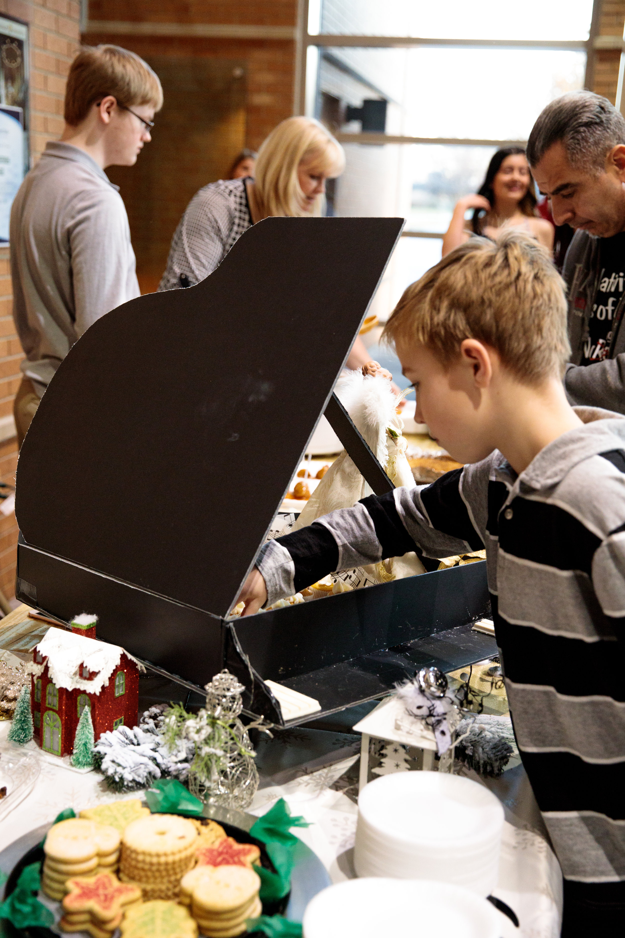 kid taking cupcake from piano-1.JPG