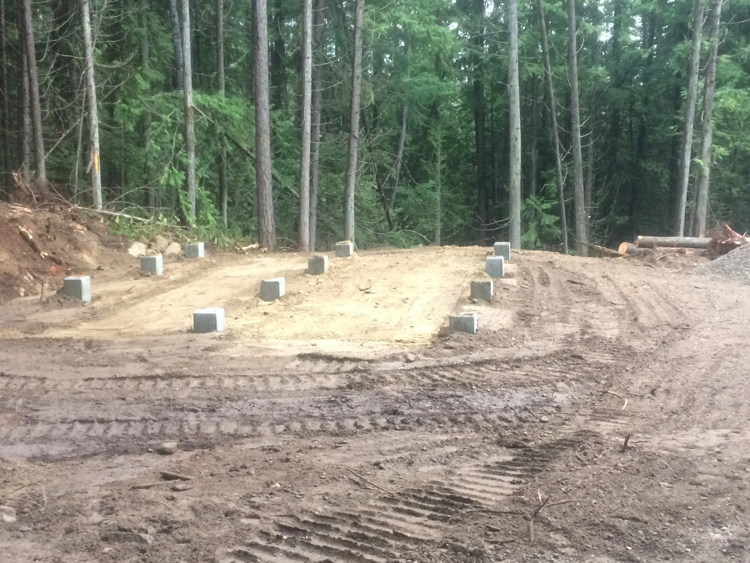 BACKFILLED PIER FOOTINGS WITH SLAB PREPPED FOR CONCRETE AND EXTERIOR GRADED FOR DRAINAGE
