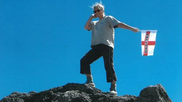energy: Linda Hart celebrates climbing Mt Taranaki with some enthusiastic flag-waving. Will she do likewise when she completes the Camino de Santiago in Spain?