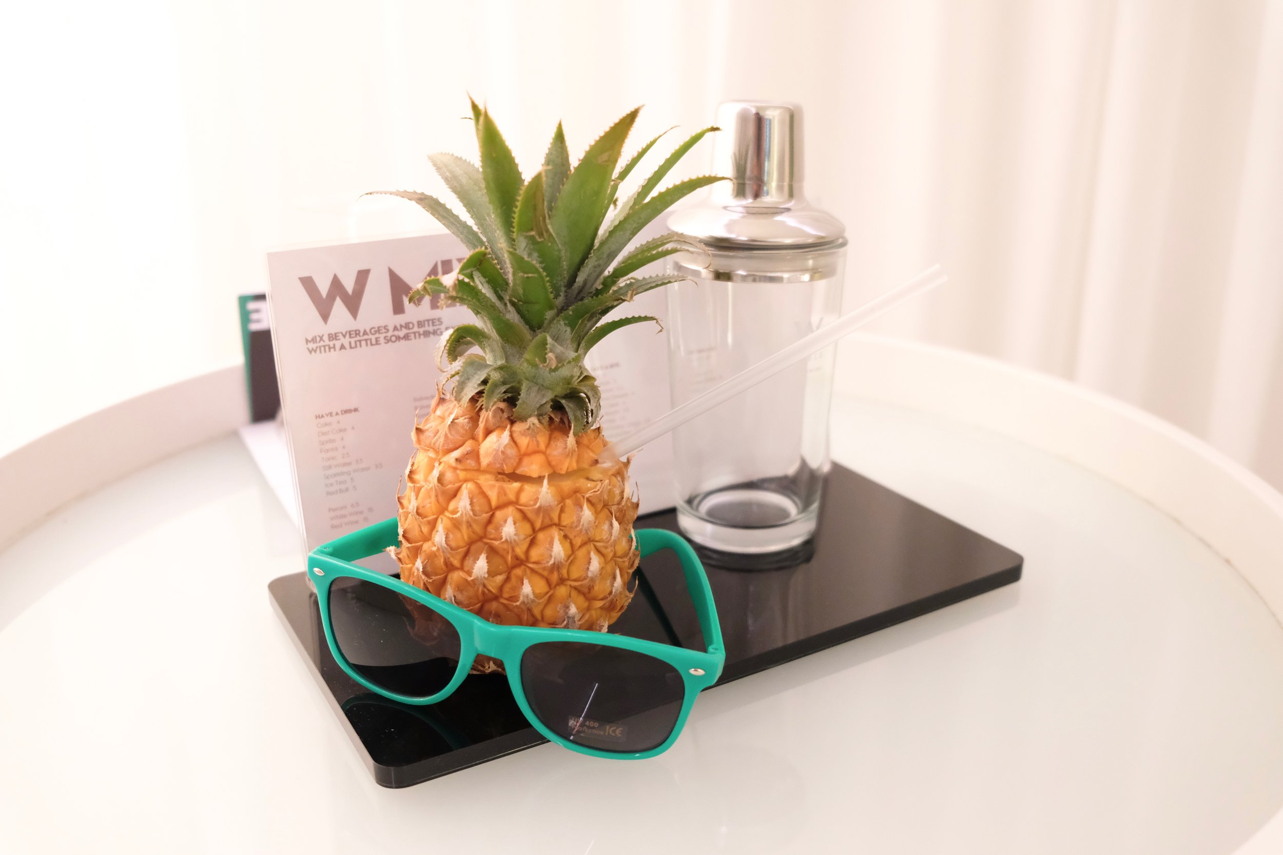 Here Comes The Sun- Ciroc Pineapple Vodka, Kings giner liqueur, topped with pineapple juice, egg white, and homemade pineapple , ginger and chili syrup. All served in a fresh pineapple cup alongside W Sunglasses. 