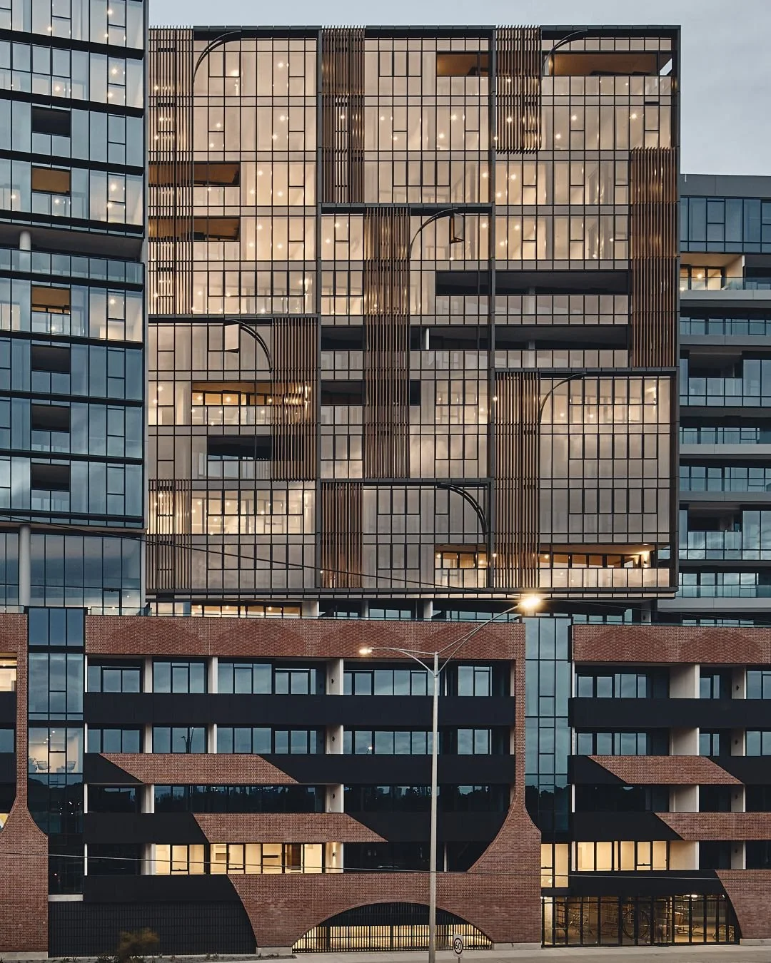 Designed by @cerastribley, the facade of Home Alphington is a masterclass in combining modern density with stunning texture. The extensive use of Krause Rustic Red Brick Tiles creates a powerful, woven-like pattern across the lower levels, giving the