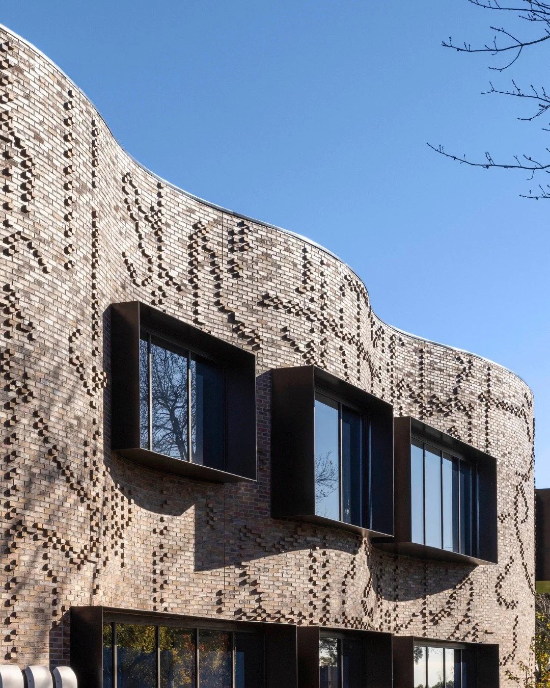 The curved facade of the Annie Hughston Centre at Fintona Girls' School is a standout moment in modern educational design. Wrapped in a custom blend of Krause Mini Empress Bricks, the building features a unique &quot;algorithmic&quot; brick pattern t