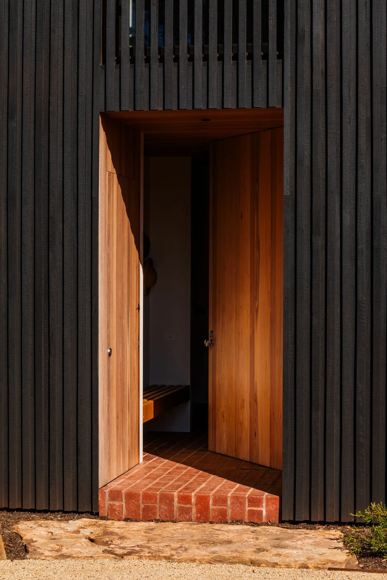 Celebrating honest materials and strong landscape connections, 'Apple House' seamlessly blurs the line between the garden and the interior.

 To anchor this transition, Krause Standard 76mm Pressed Bricks in Heritage Red are brought inside to form a 