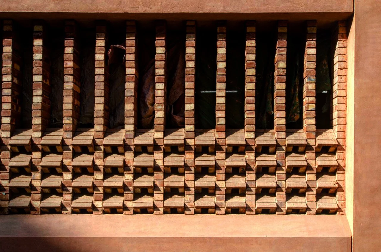  Brick screens or “jaali” help address the need for passive cooling and light in the basement. 