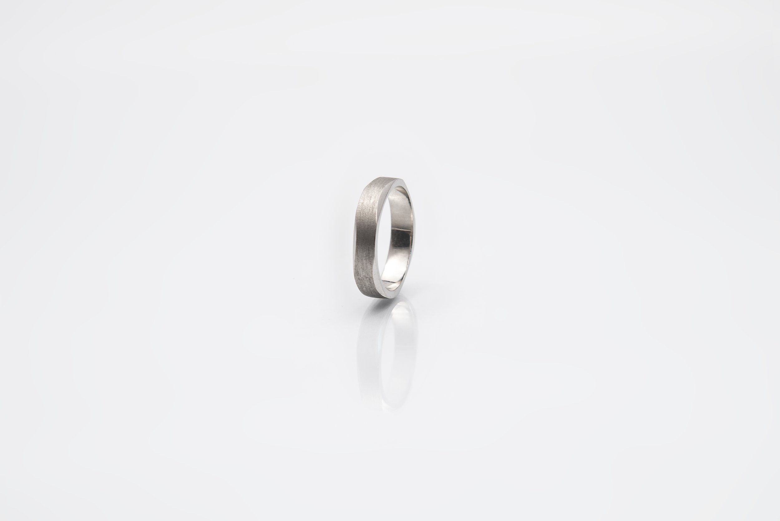 Chamfered carved  wedding band in Platinum