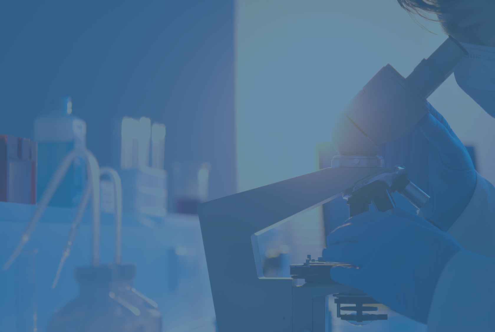 Scientist and Microscope with blue overlay.png