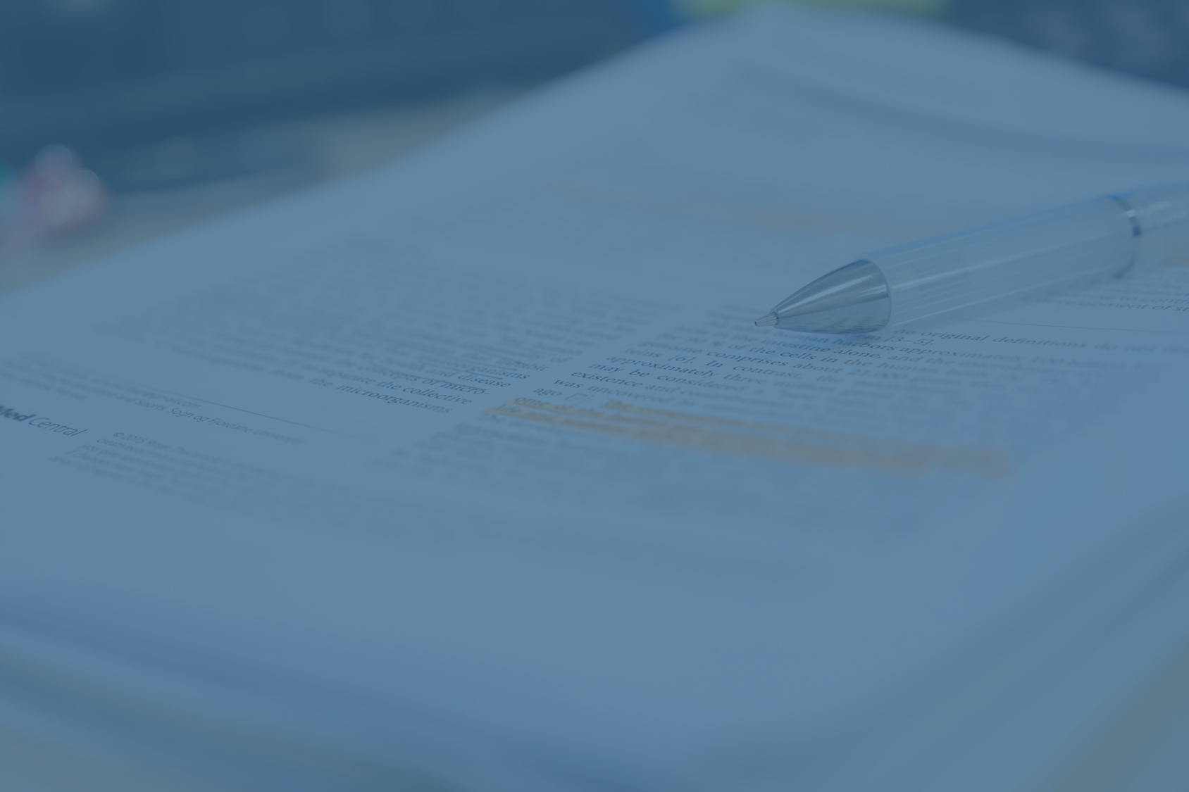 Scientific journal with blue overlay.png