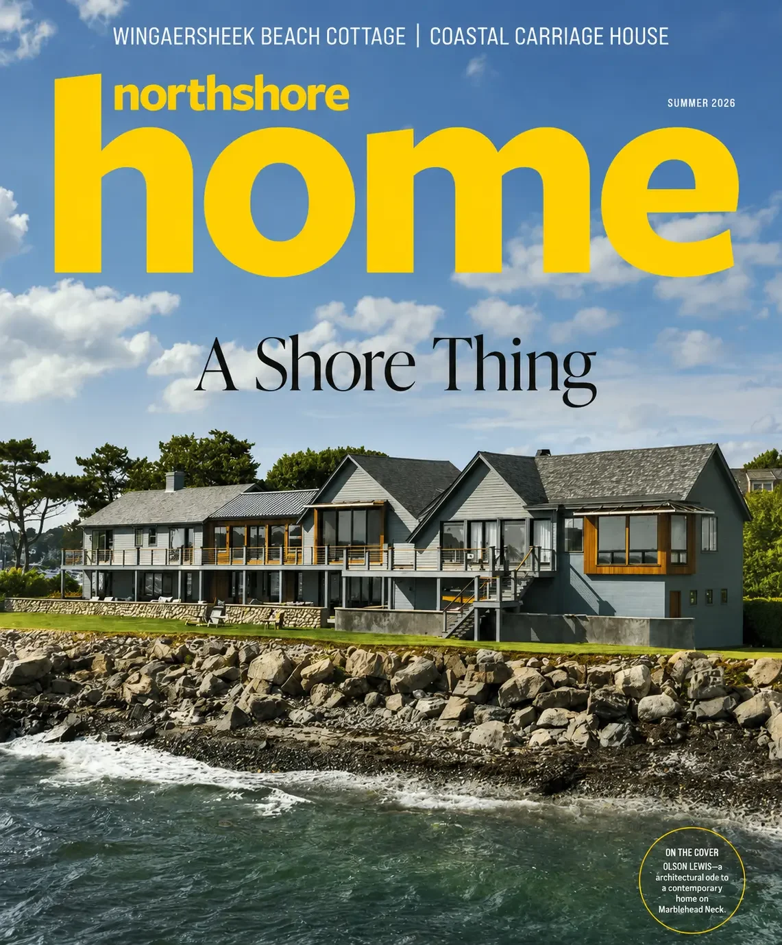 Cover of Northshore Home magazine featuring a modern beach house with a rocky shoreline and blue sky with clouds.