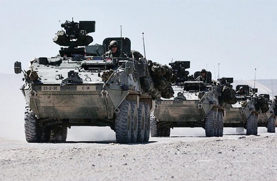 A column of Stryker troop carriers at the Army's national training center. The eight-wheeled Strykers have performed well fighting insurgents, but they need better underside protection and more powerful guns to deter Russian moves in Europe. (Public Domain, Wikimedia Commons)