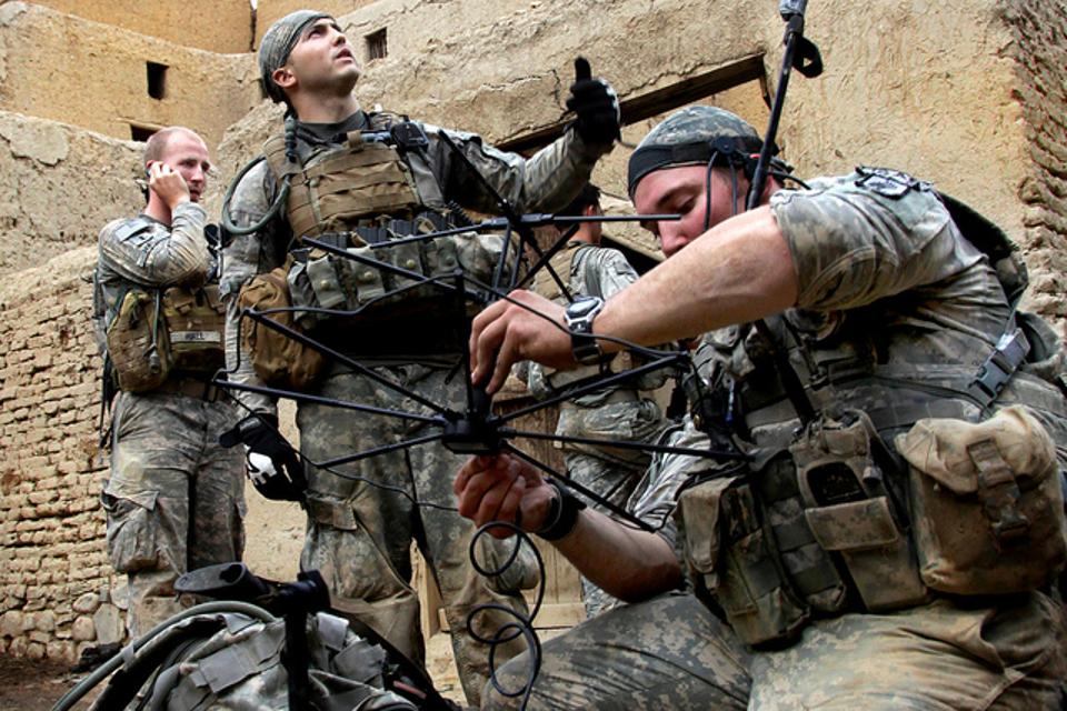 Soldiers setting up a tactical satellite link in Afghanistan. Secure communications are crucial to coordinating the battlefield maneuvers of scattered forces, but warfighters who can't move when they are communicating are at grave risk.(U.S. Army photo by Sgt. Russell Gilchrest/Released)