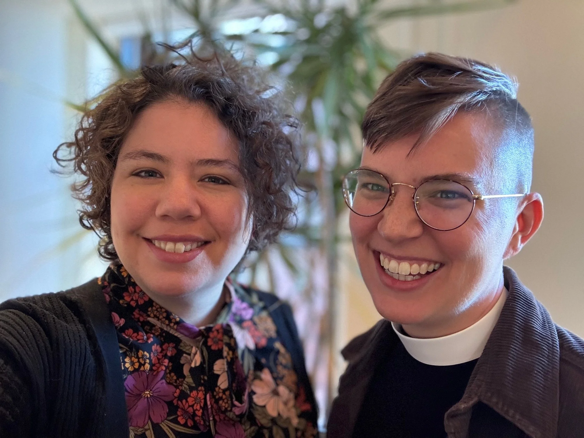 Photograph of Elizabeth in a floral top and Flourish in their priest collar