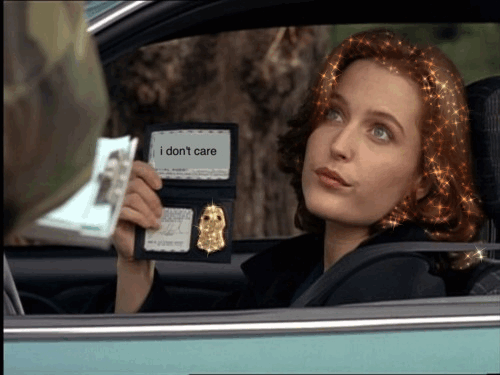 An animated gif of Dana Scully holding up her badge. Her hair and the badge both sparkle. Instead of her identification, the badge reads “i don’t care.”