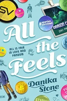 The cover of All The Feels , by Danika Stone. The title is surrounded by pins and convention badges.