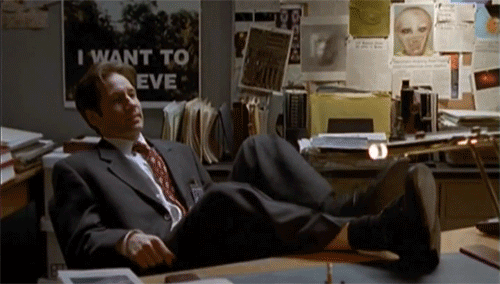 Fox Mulder, from The X-files , leaning back in his chair, overbalancing, and falling down.