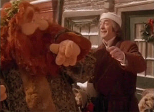 An animated gif of Scrooge dancing with the Ghost of Christmas Present, from A Muppet Christmas Carol.