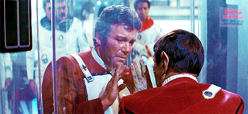 An animated gif of the moment in Star Trek 2: The Wrath of Khan when, dying, Spock offers Kirk the ta’al (Vulcan salute) through a pane of glass, and Kirk raises his hand to Spock’s.
