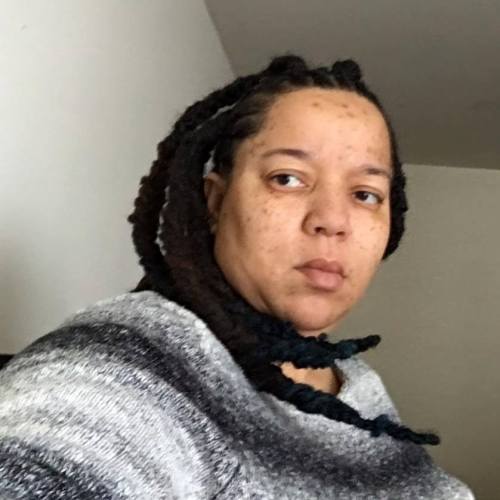 An image of Tanya DePass, wearing a warm, white-black-grey gradient sweater.