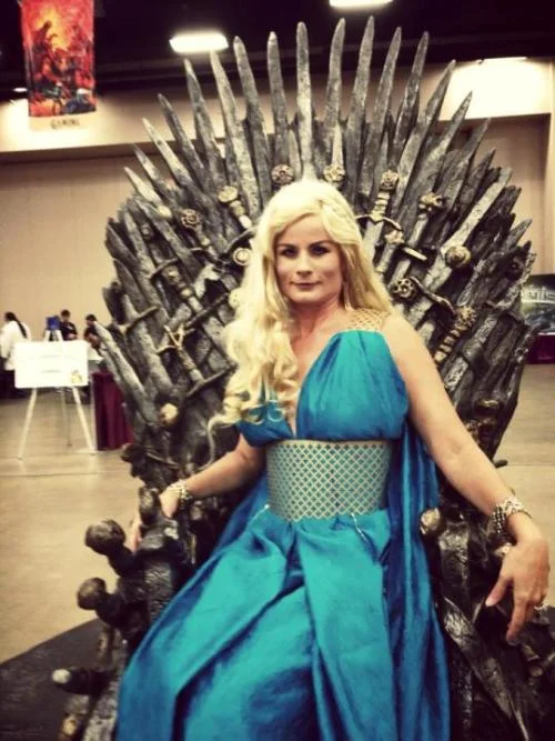 Teresa as Daenerys Targaryen, sitting on the Iron Throne. Her wig is notably iffy.