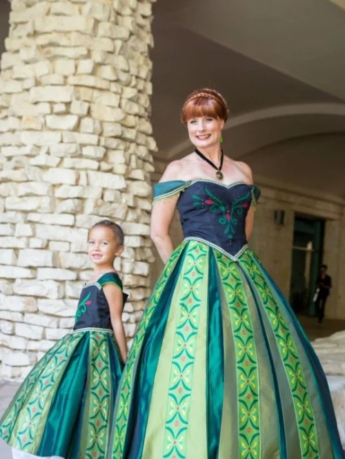 Teresa Nguyen and her young daughter Elena dressed to match as Anna from Frozen in her green costume.