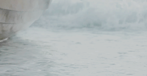 An animated gif of pirate-booted feet splashing down to stand in the sea.
