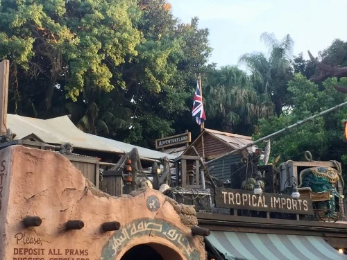 An image from Disneyland of an Adventureland fort with the British flag and the words “Tropical Imports.”