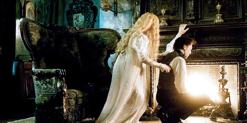 Mia Wasikowska clings to Tom Hiddleston in an animated gif from Crimson Peak. Everything is extremely Gothic.