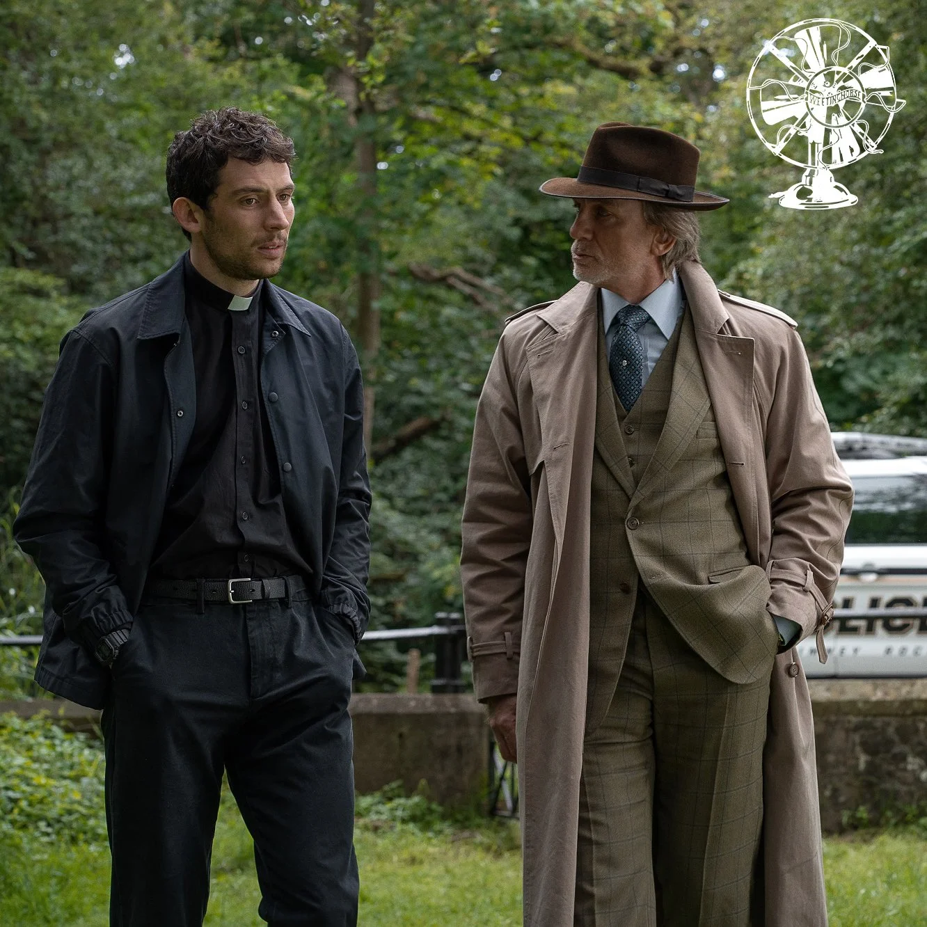 Episode cover featuring Father Jud and Benoit Blanc walking in the church yard. White fan logo in top corner.