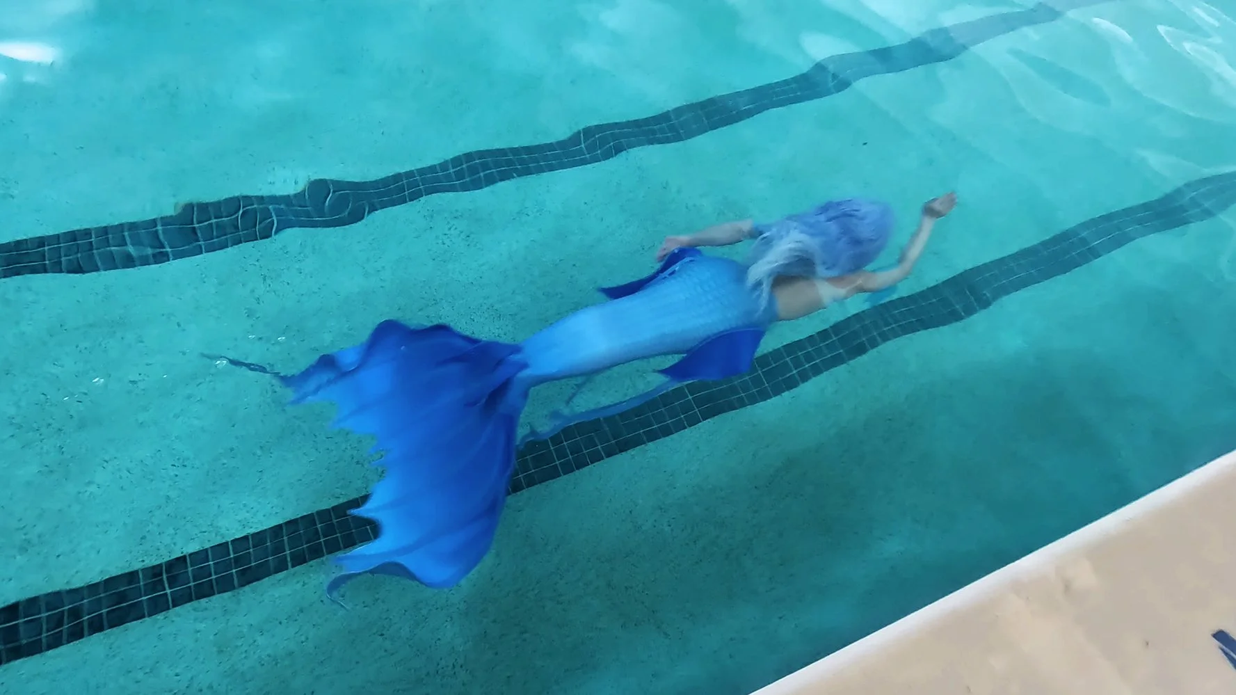 blue mermaid swimming in a blue pool with a silicone mermaid tail - the magic crafter 1.jpg