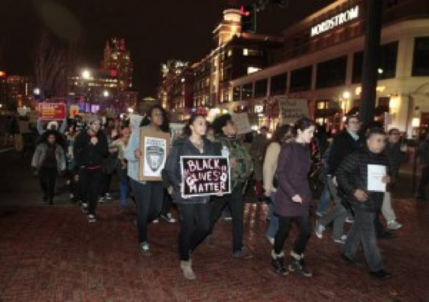Demonstrators march to the State House in downtown Providence, RI.