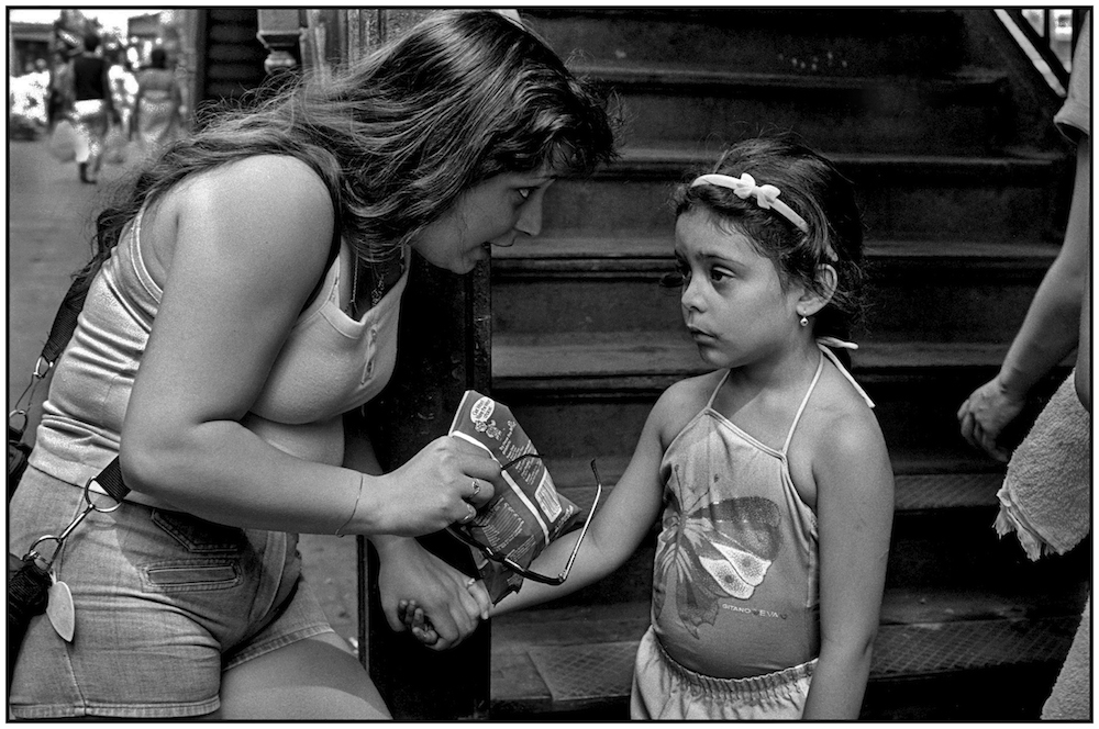 Mother and daughter in front of elevated subway stairs. Brighton Beach Avenue. July 5, 1986