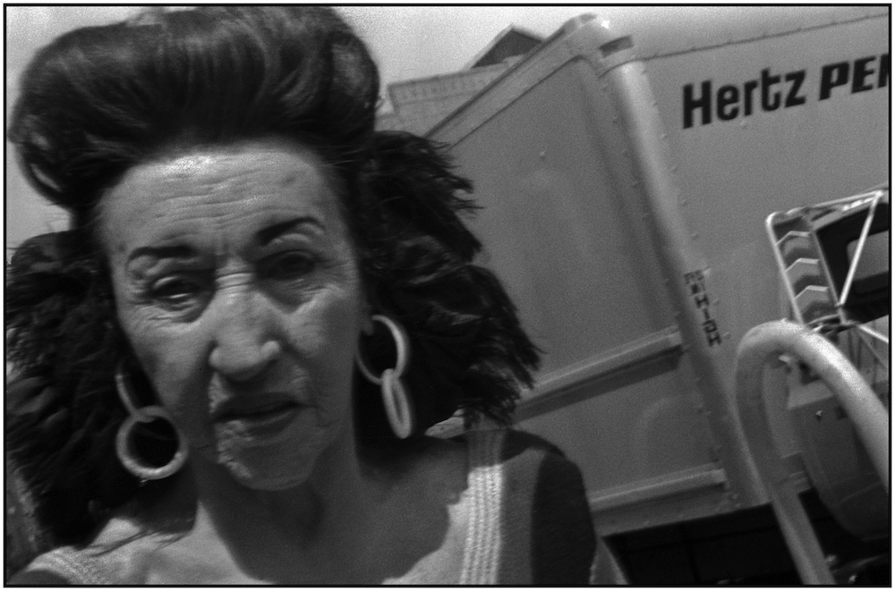 Woman and Hertz truck. Intersection of Brighton Beach Avenue and Coney Island Avenue. July 1987
